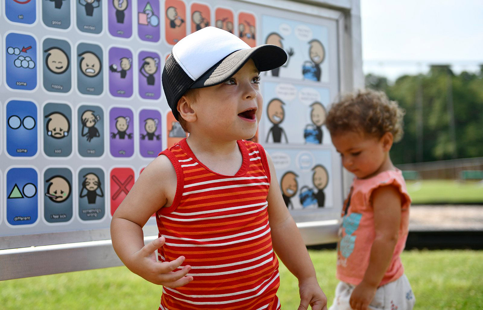 children having fun at a communication board